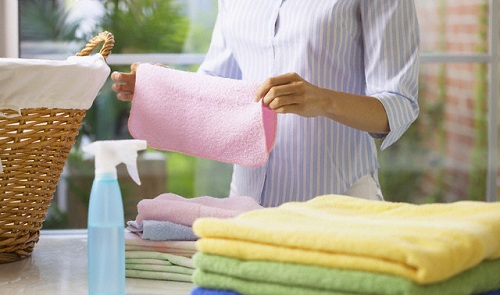 Woman Folding Freshly Washed Washcloths --- Image by © 68/Ocean/Corbis